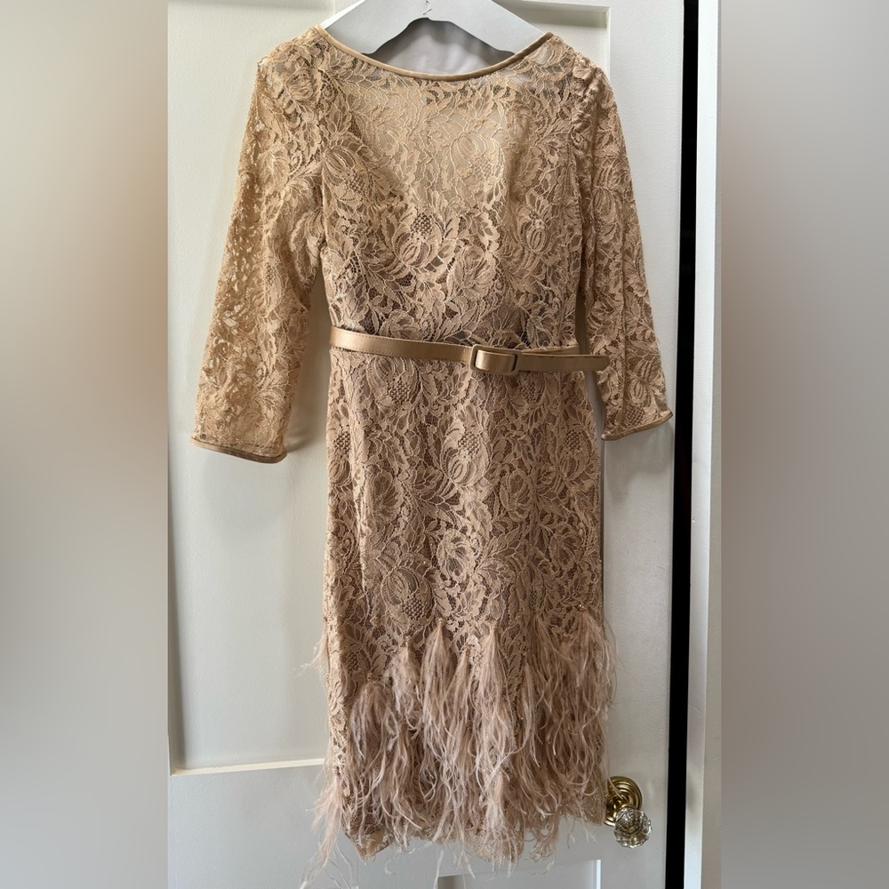 Beautiful champagne coloured dress with lace and ostrich feathers